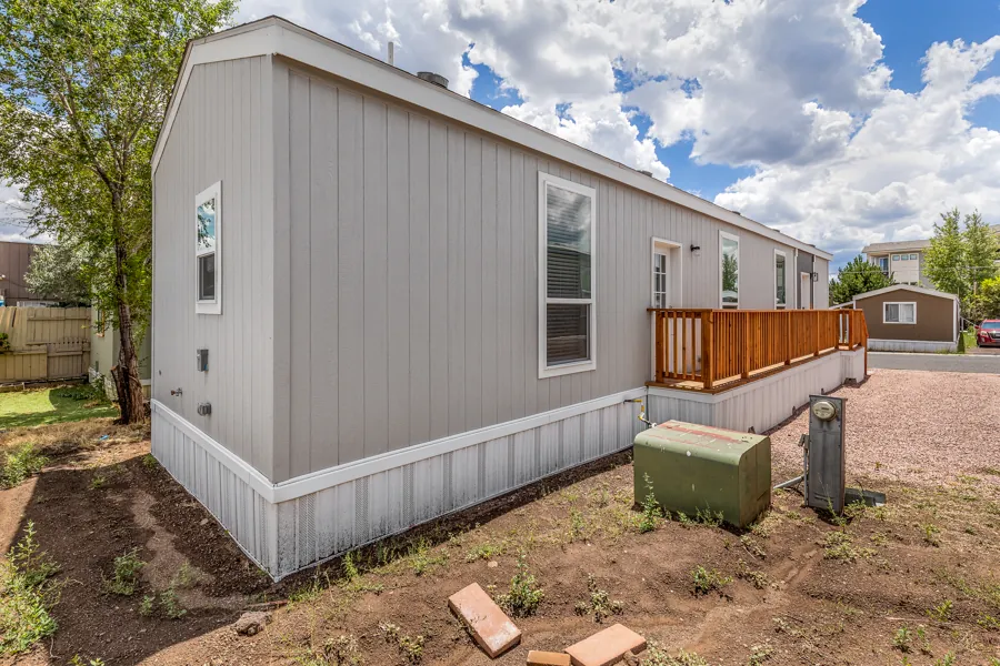 Side view of the home showing the deck and gravel yard