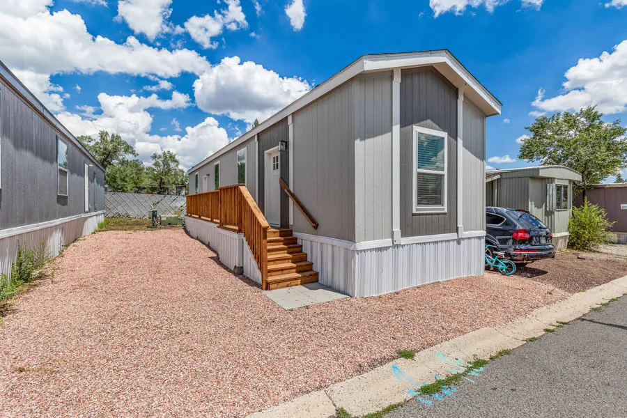 Front of the home at Colony lot 122 with its wood deck and stairs