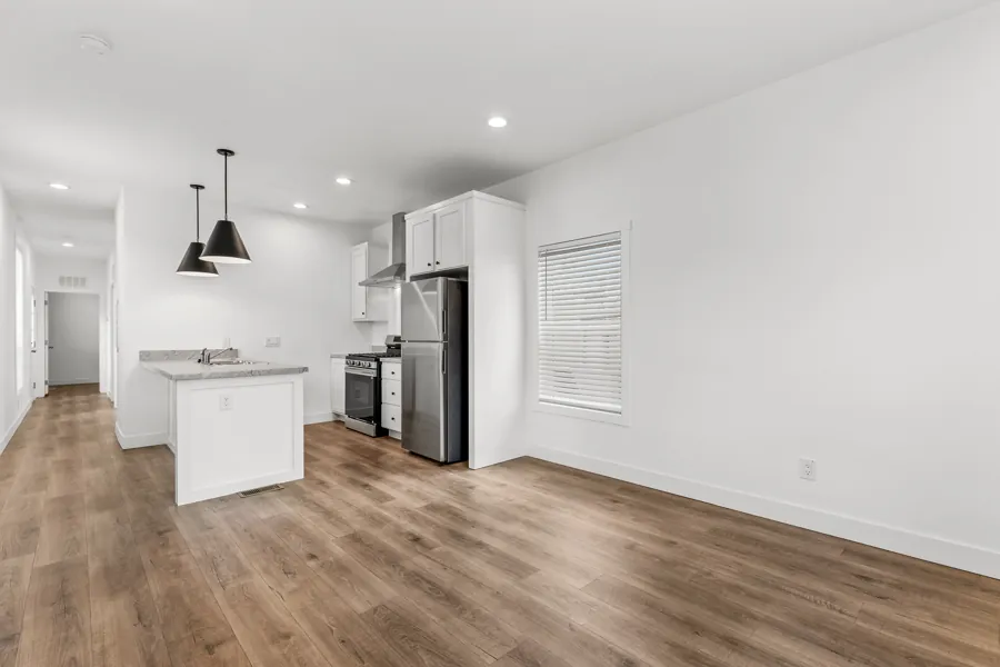Living room with vinyl plank flooring and recessed lighting