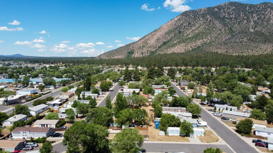 Aerial view of the Jo Don neighborhood streets in summer, with Mt. Elden in the background